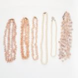 A MIXED LOT OF PEARL NECKLACES comprising of two single rows of white pearls, a five row pink