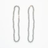 A MIXED LOT OF TWO FAUX GREY PEARL NECKLACES each comprising of a single row of faux grey pearls,