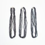 A MIXED LOT OF THREE BLACK PEARL NECKLACES each comprising of four rows of black pearls, stamped