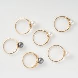 AN ASSORTED LOT OF PEARL RINGS comprising of six rings, two set with a black pearl and four set with