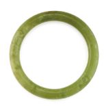 A JADEITE JADE BANGLE formed of a polished piece of green jadeite jade, 6.0cm inner diameter, 37.4g.