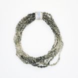 A RUTILATED QUARTZ NECKLACE comprising of seven rows of polished rutilated quartz beads, stamped