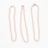 A MIXED LOT OF THREE FAUX PINK PEARL NECKLACES each comprising of a single row of faux pink