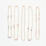 A MIXED LOT OF FIVE PEARL NECKLACES each formed of a single row of white pearls, accented by gold