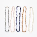 A MIXED LOT OF FIVE FAUX PEARL NECKLACES each comprising of a single row of white, pink, copper,