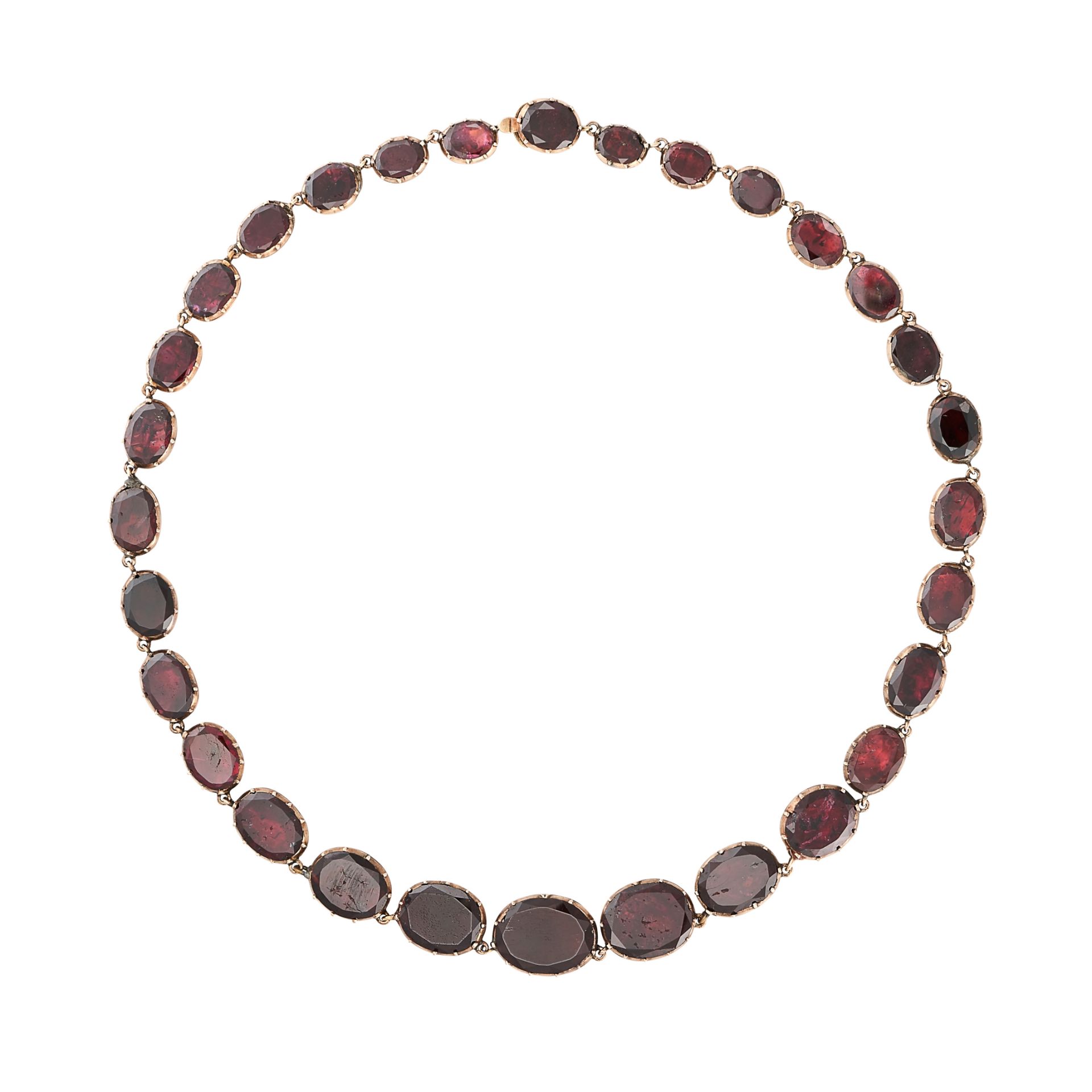 AN ANTIQUE VICTORIAN GARNET RIVIERE NECKLACE, 19TH CENTURY Graduated foil-backed oval garnets  No