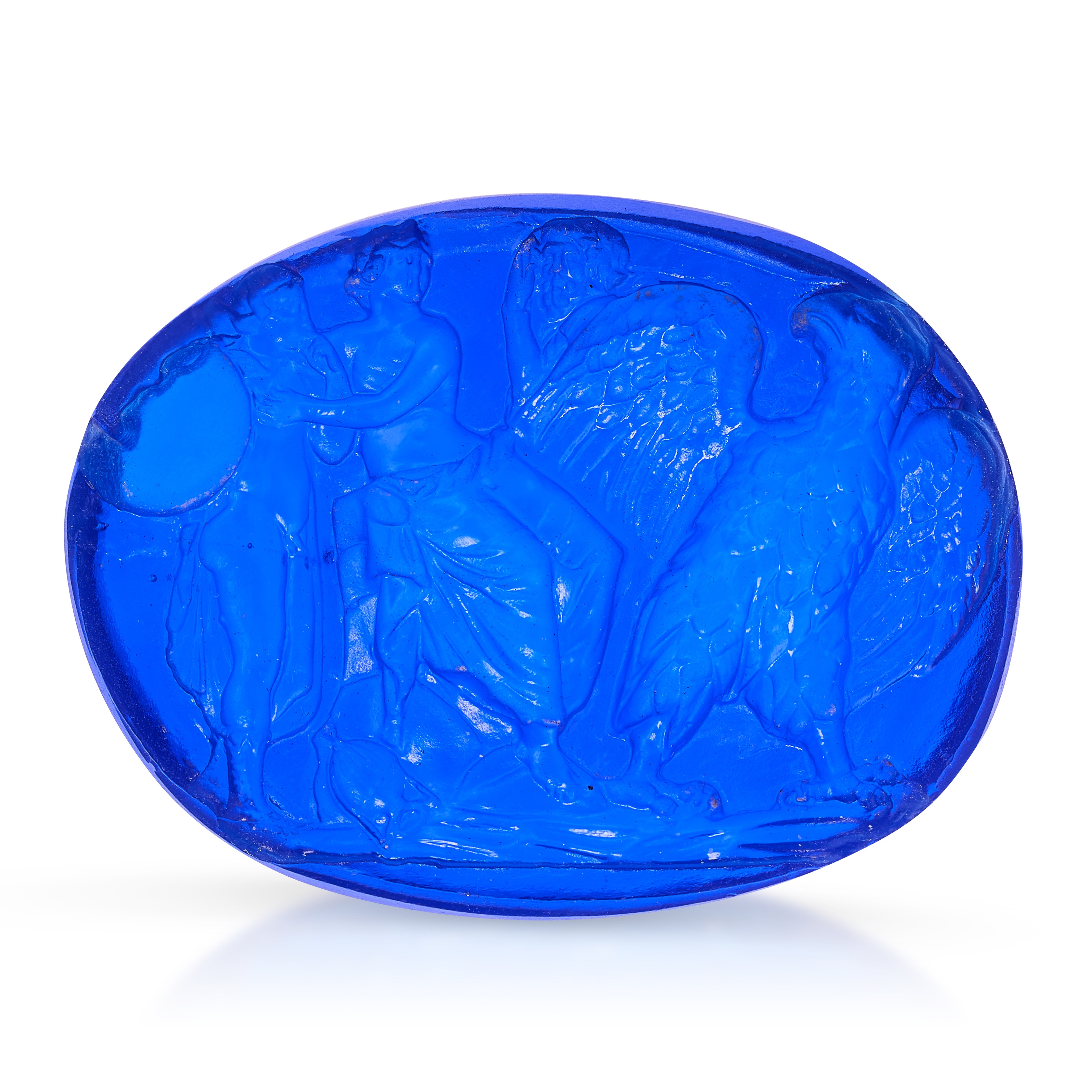 A BLUE GLASS INTAGLIO Depicting Ganymede with Venus and Jupiter emerging from his guise as an eagle,