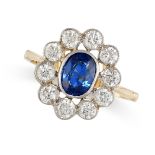 A SAPPHIRE AND DIAMOND CLUSTER RING in 18ct yellow gold and platinum, set with an oval cut blue