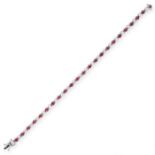 A RUBY AND DIAMOND BRACELET designed as an articulated line of claw set brilliant cut diamonds and
