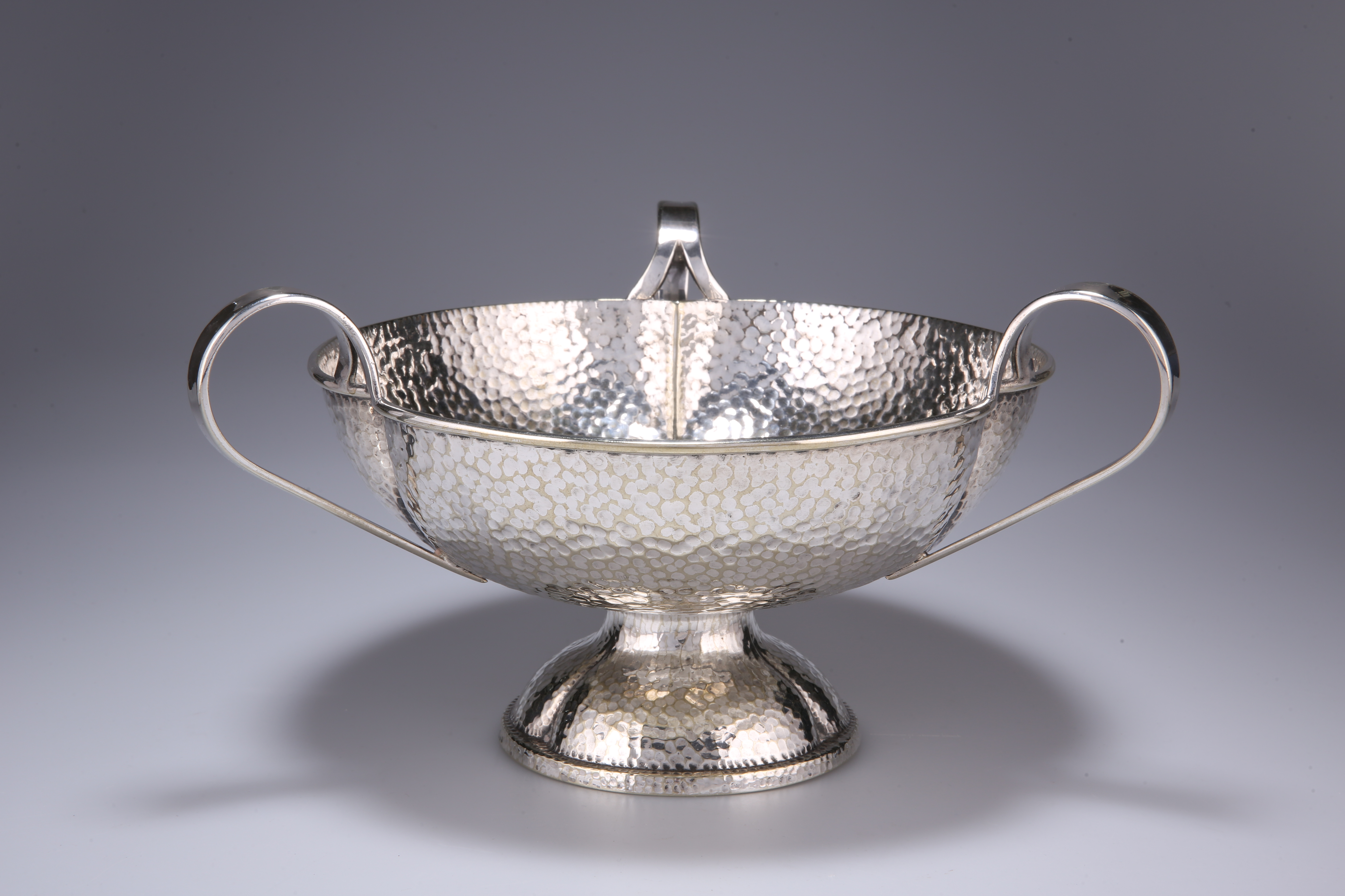 AN ART NOUVEAU SILVER-PLATED THREE-HANDLED TAZZA