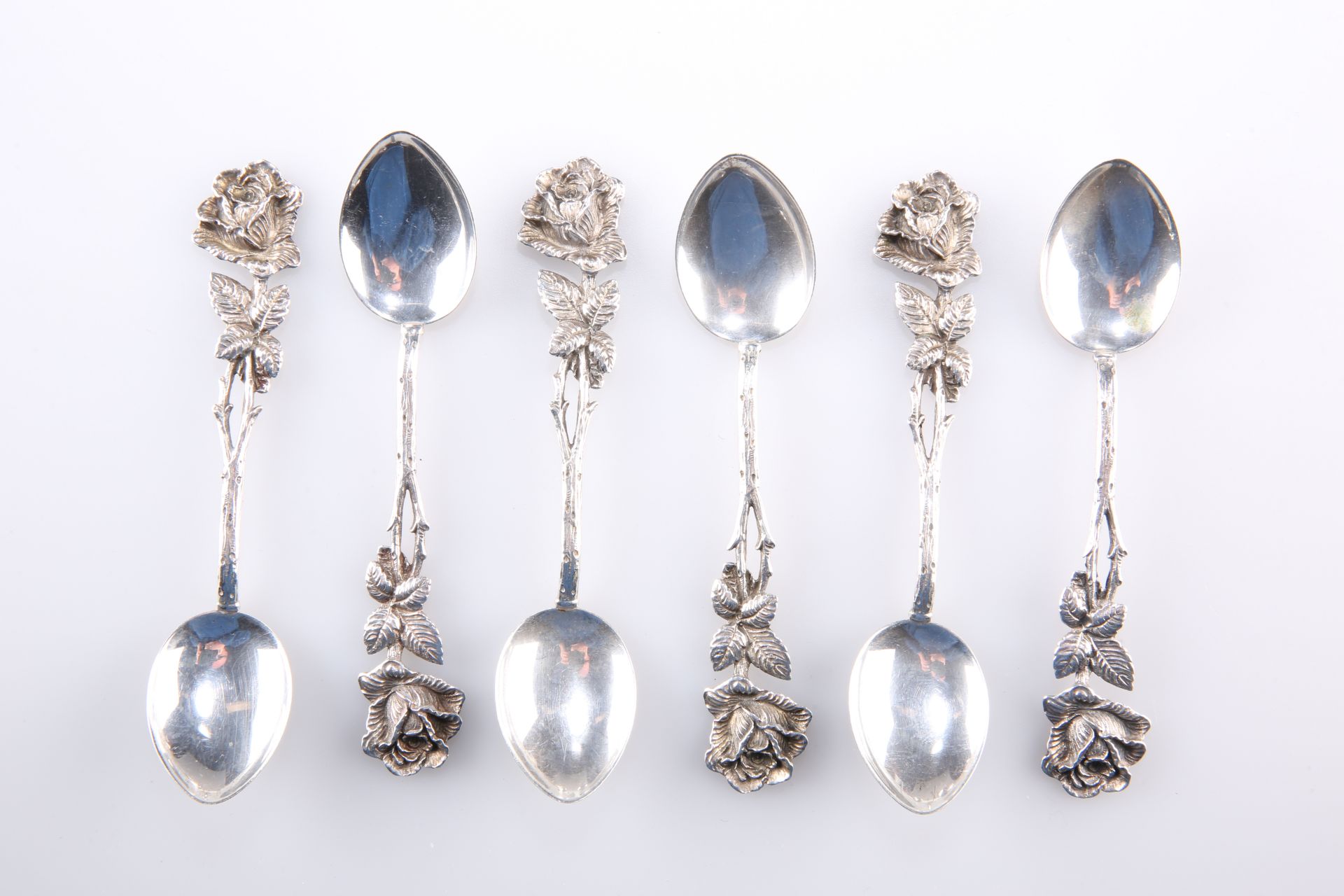 A SET OF SIX CONTINENTAL SILVER METAL COFFEE SPOONS