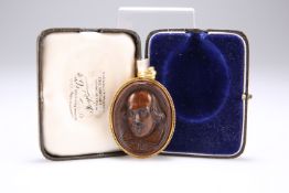 A CARVED MULBERRY WOOD DOUBLE CAMEO PENDANT