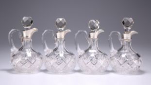 A SET OF FOUR GEORGE V SILVER-MOUNTED CUT-GLASS SPIRIT DECANTERS