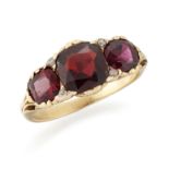 A GARNET THREE STONE RING