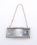 A VICTORIAN SILVER DECANTER LABEL