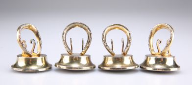 A SET OF FOUR GEORGE V SILVER-GILT NOVELTY MENU HOLDERS