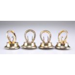 A SET OF FOUR GEORGE V SILVER-GILT NOVELTY MENU HOLDERS