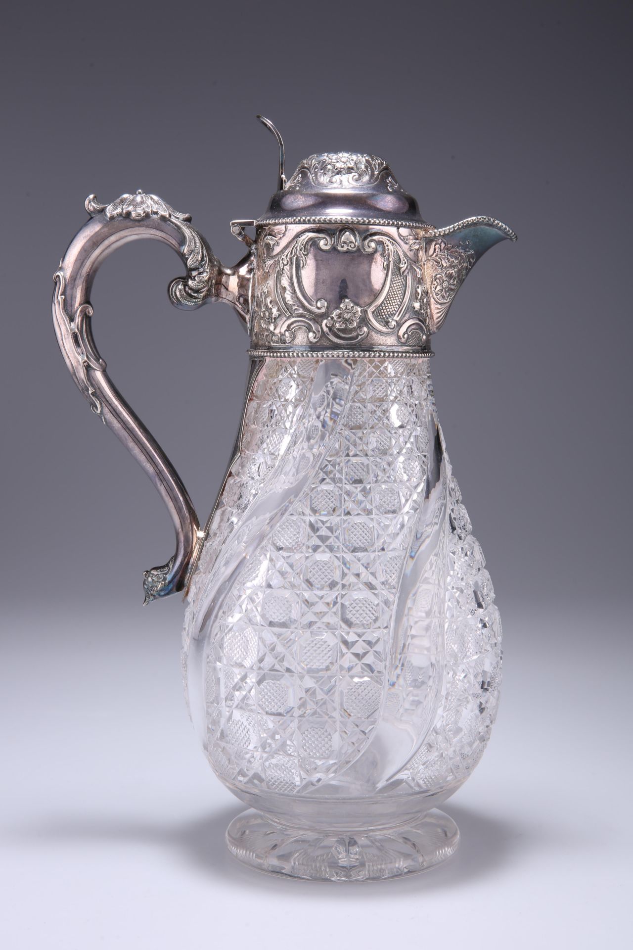 AN EDWARDIAN SILVER-MOUNTED CLARET JUG