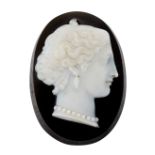 A SARDONYX CAMEO, of oval form and carved depicting a classical female bust, modelled wearing
