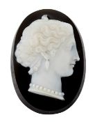 A SARDONYX CAMEO, of oval form and carved depicting a classical female bust, modelled wearing