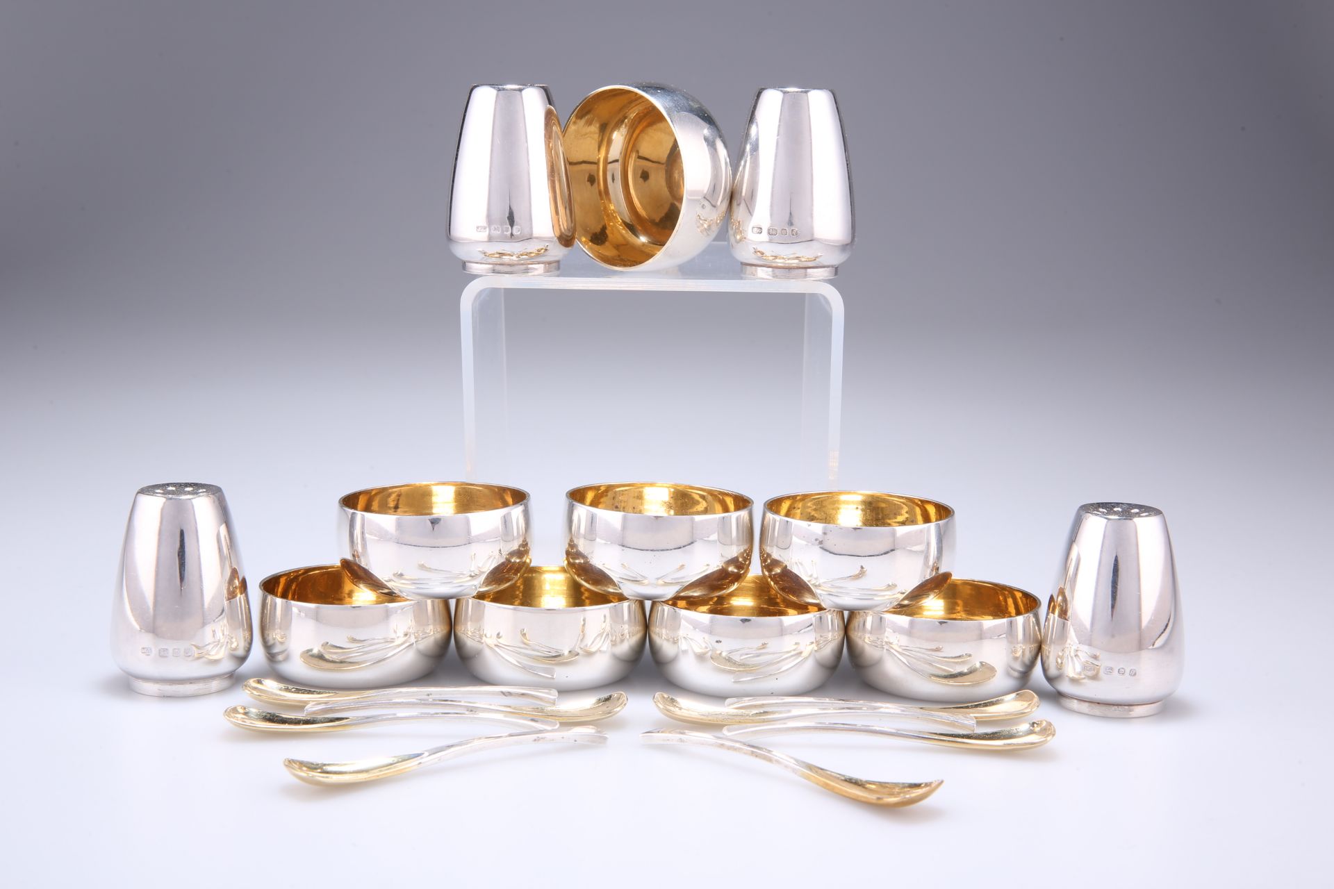 AN ELIZABETH II PARCEL-GILT SILVER CONDIMENT SET