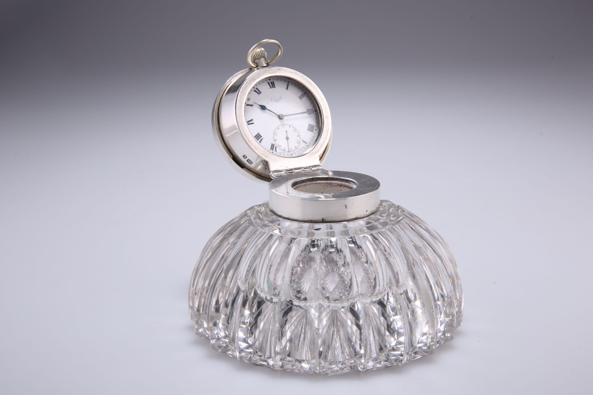 AN EDWARDIAN CUT-GLASS AND SILVER COMBINED CAPSTAN INKWELL AND WATCH STAND