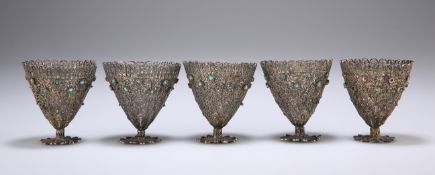 A SET OF FIVE WHITE METAL FILIGREE CUPS