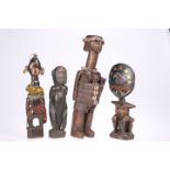 Four tribal figural carvings, including two with beadwork details, tallest 38cm