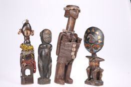 Four tribal figural carvings, including two with beadwork details, tallest 38cm