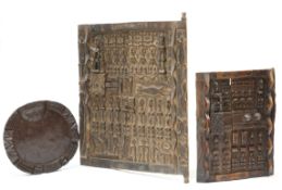 A Yoruba carved tray; together with two carved panels, largest panel 58.5cm x 48cm