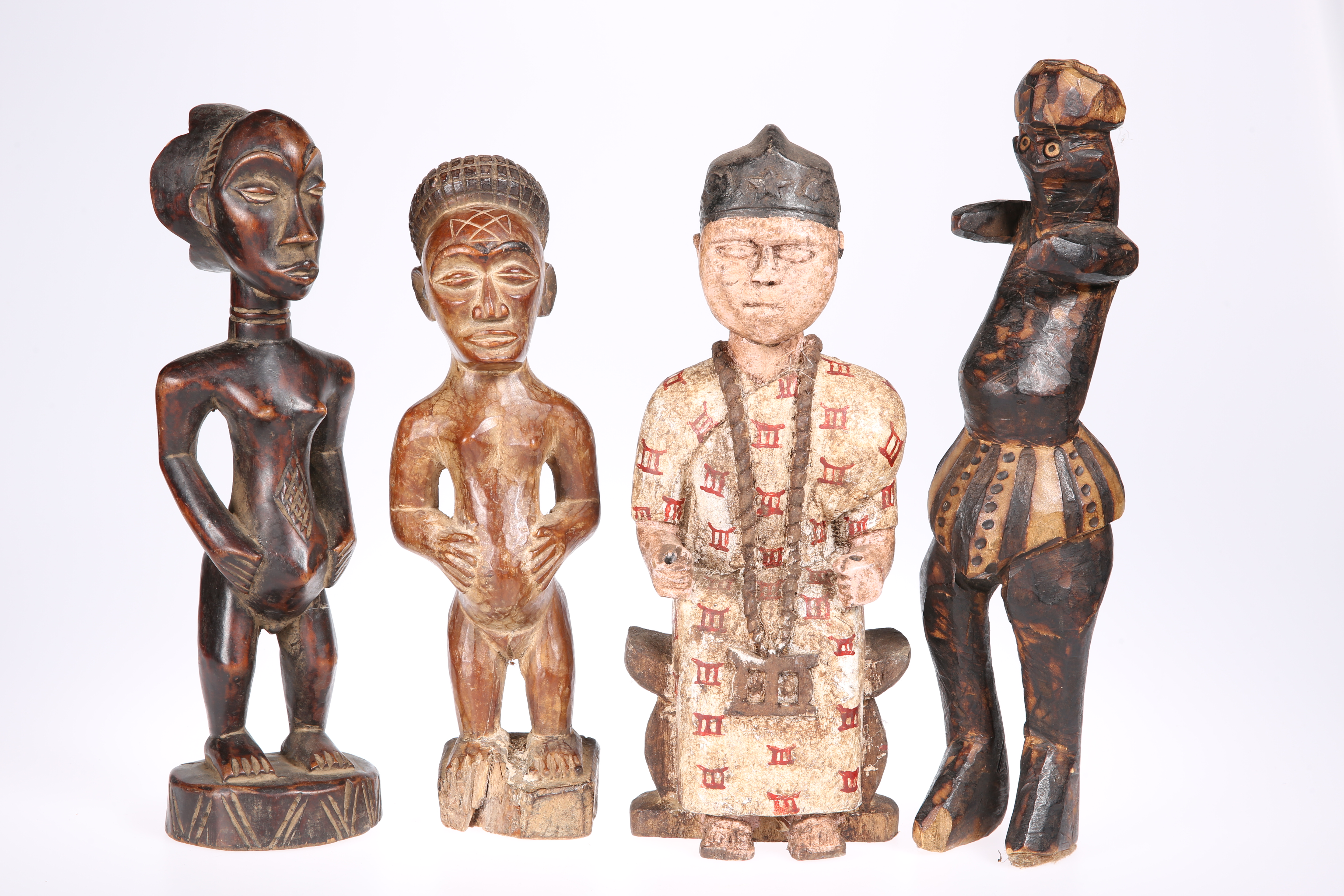 Four carved tribal figures, tallest approximately 35cm