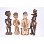 Four carved tribal figures, tallest approximately 35cm