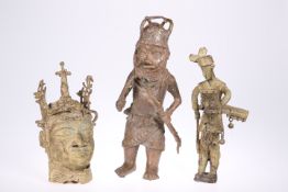 A group of three Benin bronzes comprising, a bust, and two standing figures, tallest 34cm