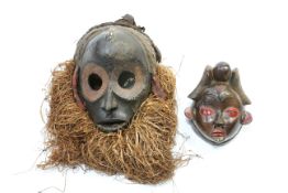 Two carved tribal masks