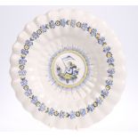 A DUTCH DELFT DISH, of fluted circular form, Makkum factory mark