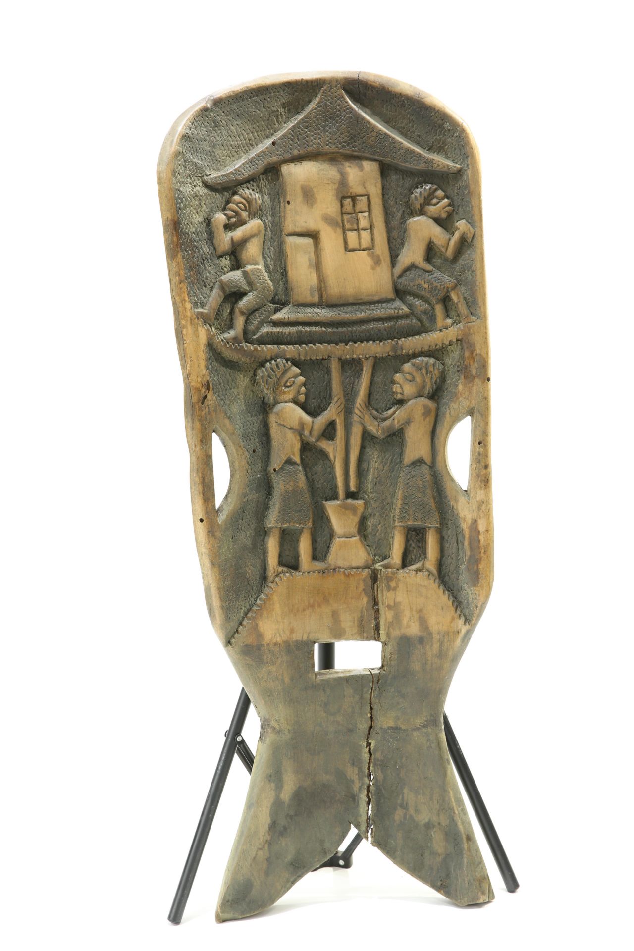 A tribal panel carved with four figures and pierced cut out handles, 112cm high