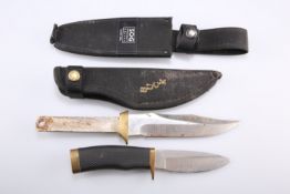 ~ AN AMERICAN BUCK HUNTING KNIFE, the 4-inch blade signed 'BUCK 692 U.S.A., with scabbard;