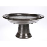 A tribal carved footed bowl, 36cm diameter