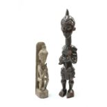 Two tribal carved figures, the first modelled as a mother and child, the first 72cm high