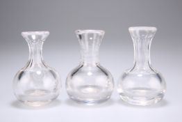 A set of three small carafes each with bulbous body, each circa 9.5cm high