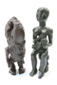 Two carved tribal figures, the first modelled as a mother and child, height of tallest 51cm