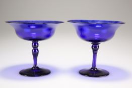 A pair of Bristol blue glass pedestal bowls, each flared bowl raised on a knot tapering stem, 11.5cm