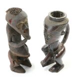 Two carved tribal figures, the first modelled as a vessel with loop handle, taller 36cm