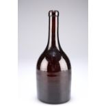 A 19th century glass bottle, of mallet shape the glass of deep red/brown colour, the base with a