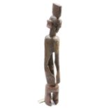 A large carved tribal figure, 122cm high