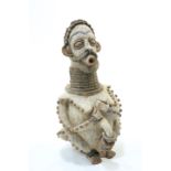 A large carved and painted tribal figure, 56cm high