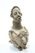 A large carved and painted tribal figure, 56cm high