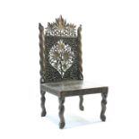 A tribal carved chair with pierced back, 93cm high