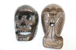 Two carved wooden masks