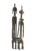 Two large carved tribal figures, each approximately 107cm high